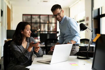 Colleagues in office. Businesswoman and businessman discussing work in office
