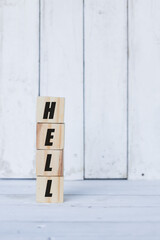 hell word or concept on wooden blocks, white wood background