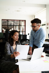 Colleagues in office. Businesswoman and businessman discussing work in office
