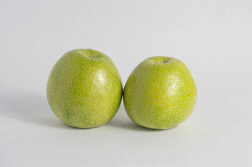 two green granny smith apples isolated on white background