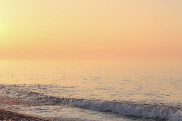 Beautiful sunset on the rocky beach . Soft peaceful water composition