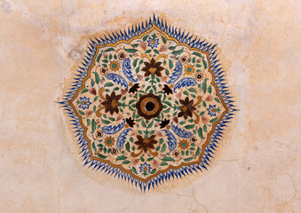 Intricate design on the walls Sheesh Mahal of  ancient Amer fort of Jaipur, India
