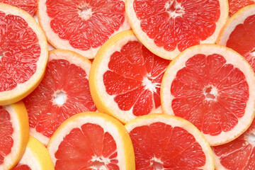 Slices of tasty ripe grapefruit as background