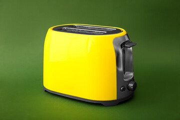 New modern toaster on green background