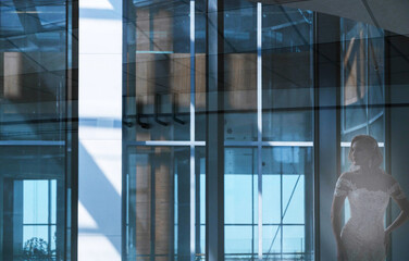 Reflection of a bride in a long wedding dress in glass
