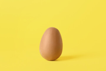Chocolate Easter egg on yellow background