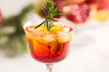 Glass of tasty pomegranate cocktail on light background, closeup