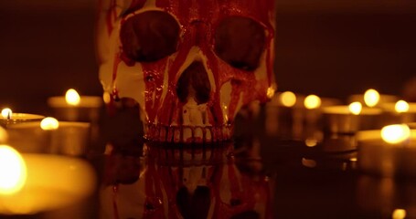 Blood stained skull against dark background closeup