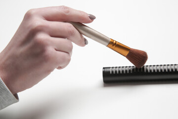 Woman using brush on microphone to make ASMR sounds