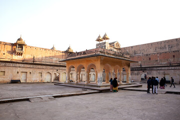 Fototapeta na wymiar JAIPUR, INDIA - JANUARY 12: Tourist visits a courtyard inside ancient Amer fort of Jaipur on 12 January, 2022.