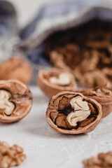 Many walnut kernels close up in eco bag on a white background. Healthy eating concept.