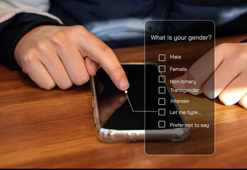 Teenager boy describe self gender choose to filling personal gender from online on smartphone.
