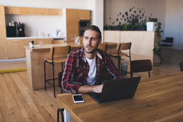 Millennial businessman working at desk in office © BullRun