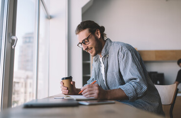 Caucasian businessman work at windowsill in office