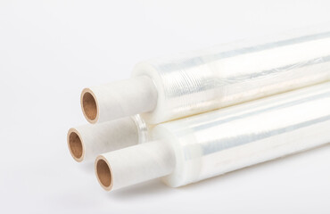 Roll of plastic stretch film with clear wrap. It stands in an isolated environment. It is used in the packaging of products. Overlapping stretch films