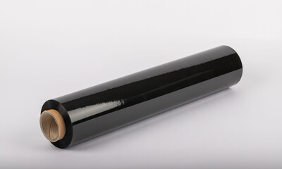Roll of plastic cling film with black wrap. how long the roll of cling film can stretch is shown. It stands in an isolated environment. It is used in the packaging of products.