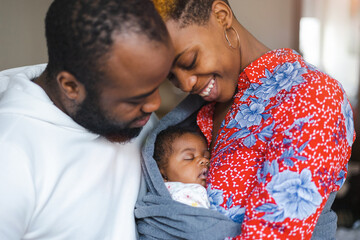 Young parents with their baby girl at home
 - obrazy, fototapety, plakaty