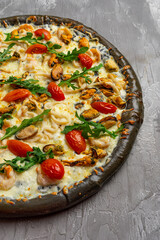 Delicious seafood pizza on light grey table, top view. Space for text