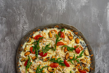 Delicious seafood pizza on light grey table, top view. Space for text