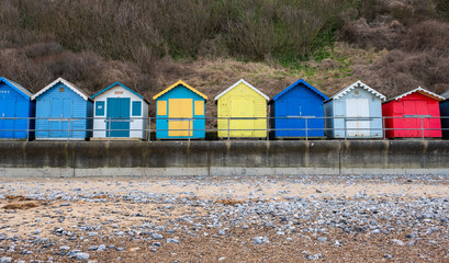 Fototapeta na wymiar Traditional wooden beach huts on the promenade in the seaside town of Cromer on the North Norfolk Coast