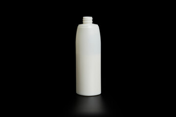 Unbranded bottle of shampoo, cream rinse, cream or beauty product with purple cap on black background with reflection below.