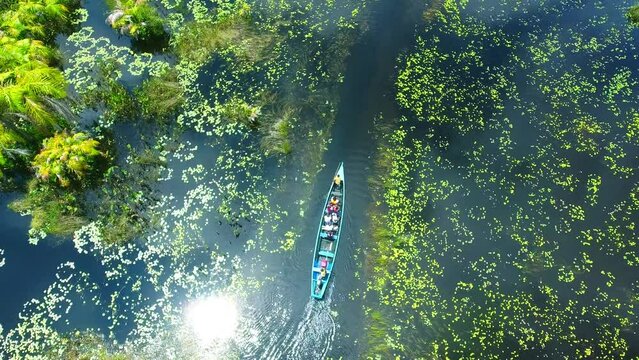 Top down shot of boat on Amansuri Lake in Ghana