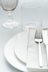 Beautiful and romantic table setting  in white  colors. Holiday table decoration. Selektive focus on fork..