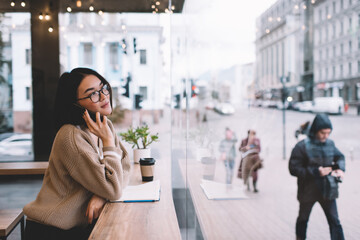 Fototapeta premium Young millennial asian girl resting in cafe
