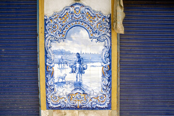 Typical Portuguese Azulejos or Blue tiles with traditional rural scenes, on the facade of Mercado...