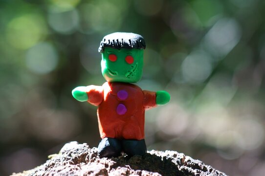 Funny Frankenstein from plasticine close-up. A monster figurine. Halloween.