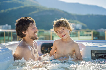 Portrait of young carefree happy smiling happy family relaxing at hot tub during enjoying happy...