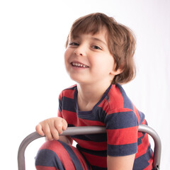 little boy making funny expressions  and posing with many faces and thinking 