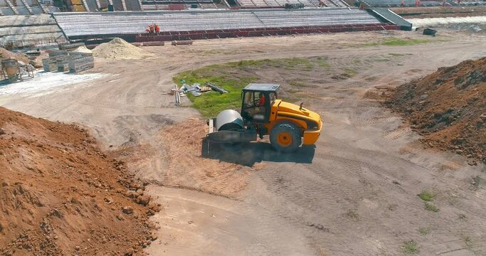 Soil Compactor aligns earth on a construction site. Soil Compactor compacts the ground at a construction site