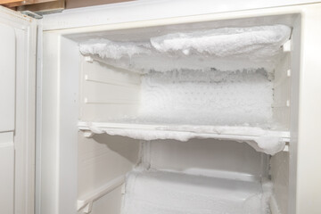Ice inside a fridge. Defrosting freezer.
