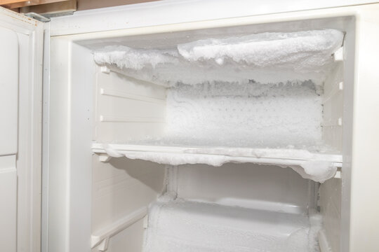 Ice inside a fridge. Defrosting freezer.