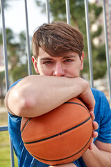 portrait of a man looking at the camera with a basketball in his hand