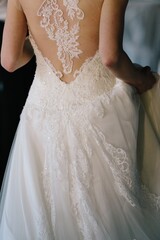 Obraz na płótnie Canvas Cose-up of a bride's back and her wedding dress