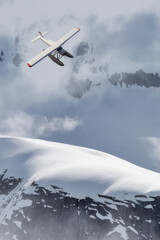 Fototapeta na wymiar View of Canadian Mountain Landscape with Seaplane Flying. Dramatic Cloudy Sky Art Render. 3d rendering Airplane. Aerial Background image from British Columbia, Canada. Adventure Travel Concept