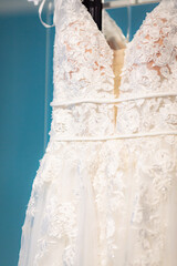 Close-up shiny symbolic flowers pattern on classical white wedding dress