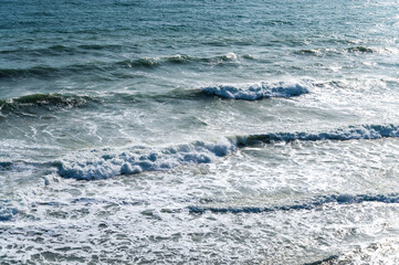 Storm on the blue sea, waves with foam
