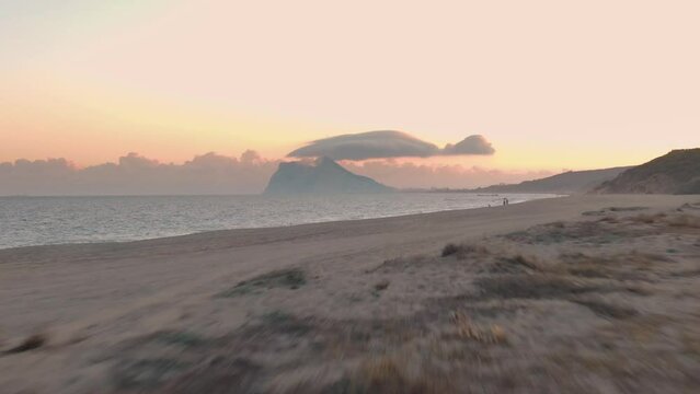 Aerial drone view of the Rock of Gibraltar at sunset from the beach of La Linea de la Concepción, Spain 