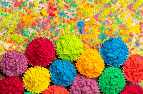 Happy Holi! A colorful festival of colored paints made from powder and dust. Colorful holi powder background. Holiday of bright colors Indian tradition. © Vera