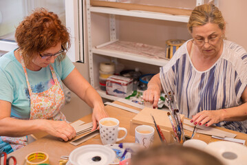 Women in art workshop making decoupage boxes