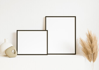 Boho Style Horizontal 8x10 two Black Frames mockup. Clean Black frame on white wall with boho plant and a vase. 3d rendering.