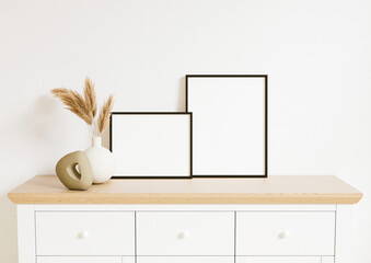 Boho Style Vertical and Horizontal 8x10 two Black Frames mockup. Vertical and horizontal Black frame on a cupboard with plant in a vase. 3d rendering.