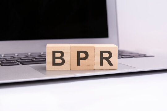 bpr - wooden cubes with letters on a laptop keyboard