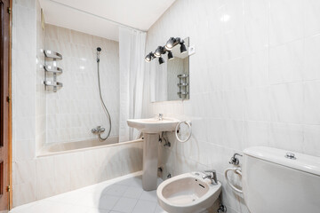 Bathroom with stainless steel fixtures, fabric curtained tub and cream toilets