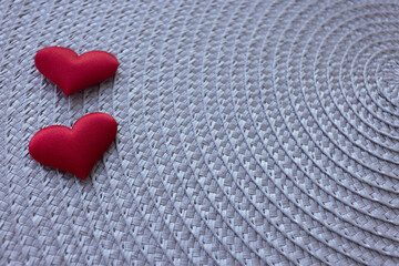 Fototapeta premium Two hearts on a grey wicker background.