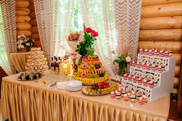 Sweet cakes in cups at a wedding buffet. Candy bar catering