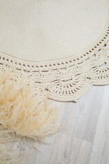 Handmade carpet knitted from natural threads, flooring, natural cotton. Beige handmade carpet. Interior solution for a house or apartment
